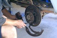 Mechanic  Hard @ Work Pulling the last drum brake assembly out